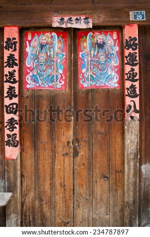 GUILIN, CHINA - OCTOBER 3: Close up of chinese doors with posters of gods to protect from the demons, on October 3, 2010 in Guilin, Guangxi, China