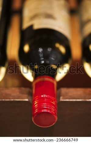 Bottles of red wine on a wooden shelf