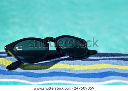 Swimming pool, sunglasses and bath towel