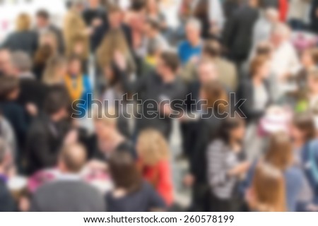 Blurred background of unrecognizable people at a social event