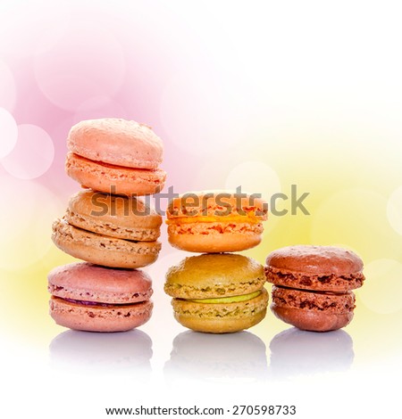 Stack of pastel french macarons, square bokeh background