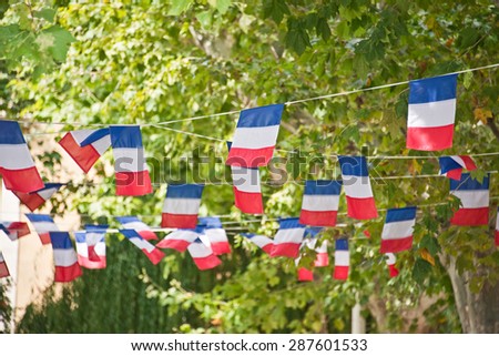 French flags garland decorating a village square