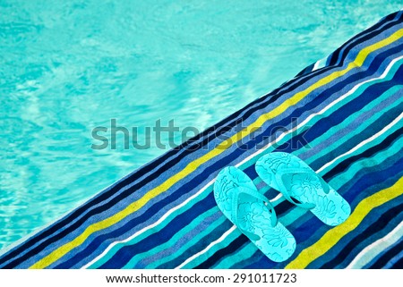 Swimming pool, bath towel and flip flops