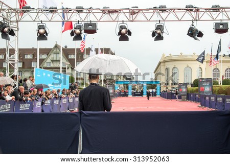 DEAUVILLE, FRANCE - SEPTEMBER 5: Fans waiting under the rain for actors and celebrities on the red carpet during the 41st Deauville American Film Festival, on September 5, 2015 in Deauville, France