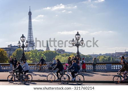PARIS, FRANCE - SEPTEMBER 27: People on bicycles and pedestrians enjoying a car free day on Alexandre III bridge on September 27, 2015 in Paris, France