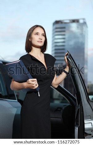 young businesswoman with a car
