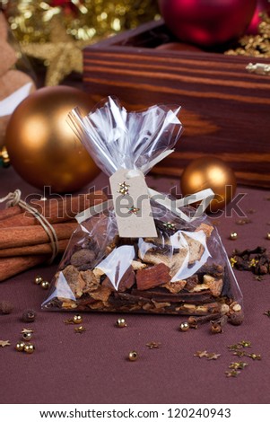 Gift set of various spices with red and golden christmas baubles