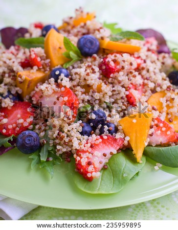 Sweet quinoa salad with berries and fruits, shallow depth of field, selective focus