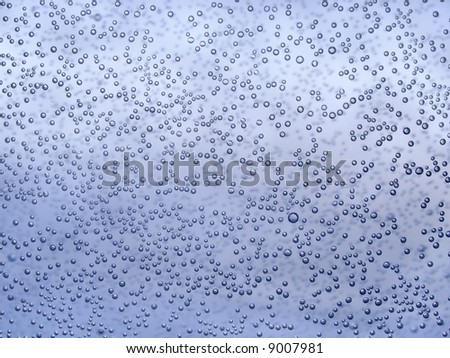 Bubbles of air on the glass inside water environs