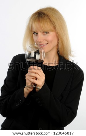Blond executive woman toasts with wine glass with provocative expression