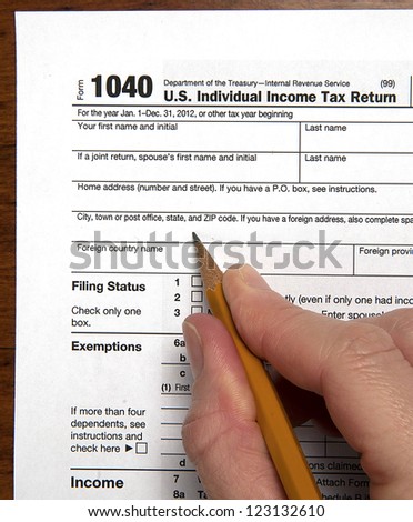 United States tax return form with hand holding sharpened pencil