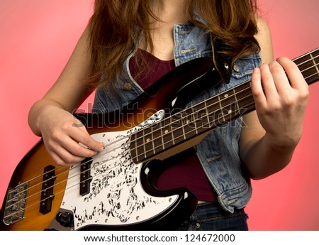 Young woman  punk woman playing bass guitar