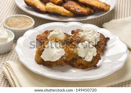 Traditional Jewish Hanukah dish of Latkes or potato pancakes with sour cream and apple sauce