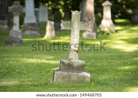 Ancient cross grave marker in cemetery