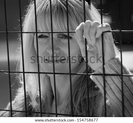 Woman trapped on outside of metal fence looking inside