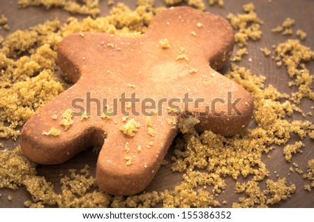 Brown sugar with clay man-shaped moisturizer on wooden plank