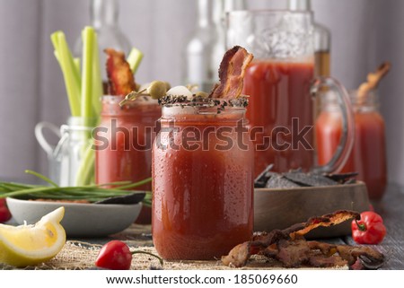 Table arrangement with pepper smoked bacon bloody mary or caesar in mason jars