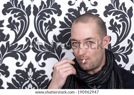 Hipster man with tie and scarf with cigarette in mouth