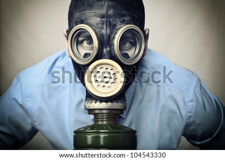 portrait of man wearing classic russian gas mask