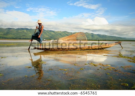 Myanmar hi res photo of traditional fisherman on his canoe