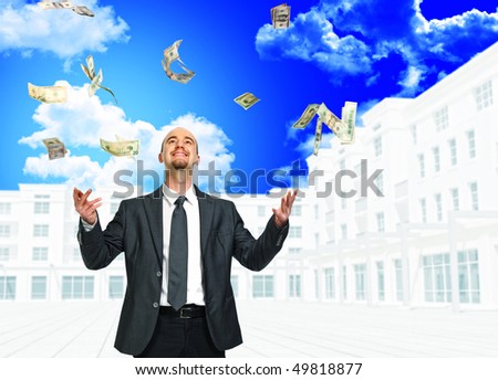 young businessman and money rain with building background