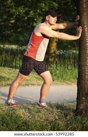 young runner warm up his muscle before start run