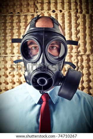portrait of businessman wearing classic gas mask