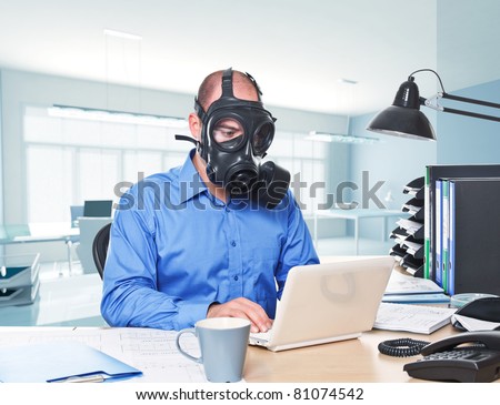 man wearing gas mask work with laptop