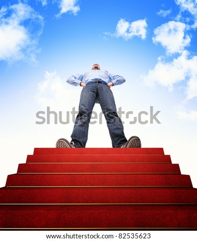 standing man and stair with red carpet