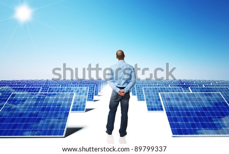 lots of solar panel and blue sky with man back view