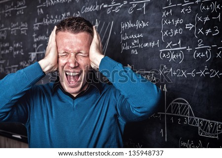 young caucasian desperate teacher portrait with blackboard
