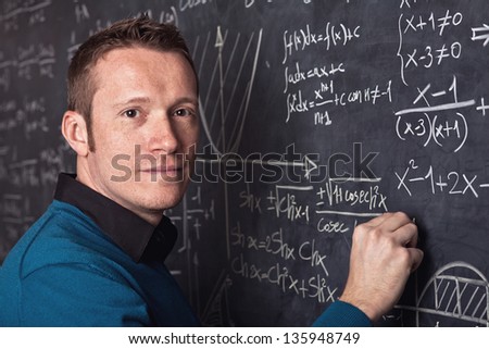 young caucasian teacher portrait with blackboard background
