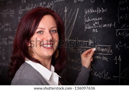 portrait of woman teacher and blackboard background