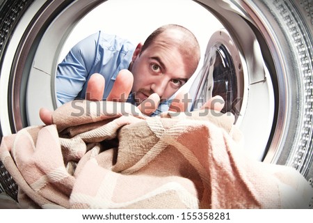 man portrait from inside of washing machine