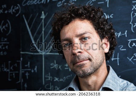 portrait of caucasian teacher and blackboard background