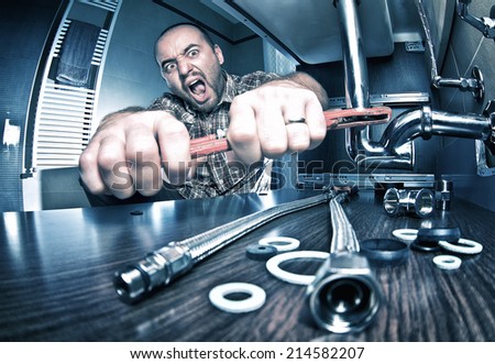 portrait of angry plumber at work