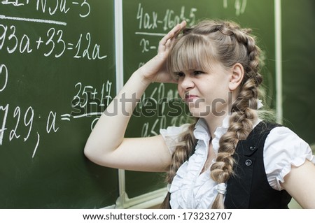 Schoolgirl at the blackboard in math
