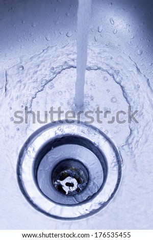 Kitchen Sink/ Stock Image/ Vertical Shot/ Close-up of Kitchen Sink With Water Running Down The Drain