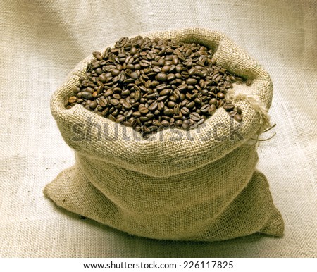 Big Bag Full Of Delicious Coffee Beans On Burlap Background