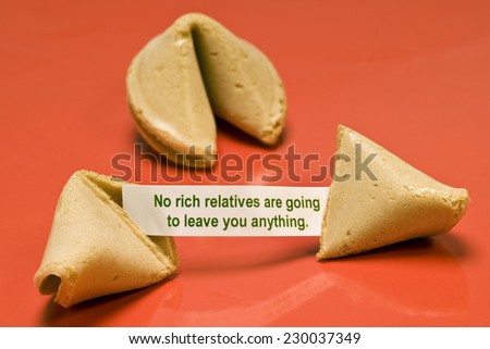 Horizontal broken fortune cookie saying \'No Rich Relatives Are Gonna Leave You Anything\'.