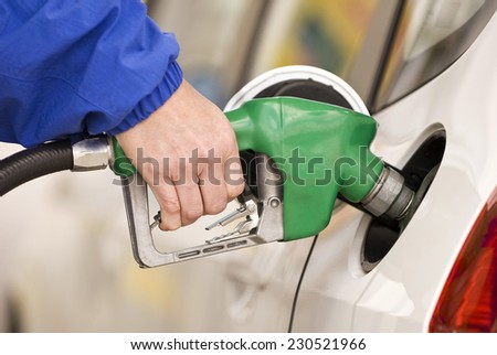 Horizontal Shot Pumping Gas Into Tank/ Another Fill-Up/ Focus On Hand And Pump Handle