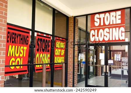 Horizontal Shot Of 'Store Closing' Signs On Building