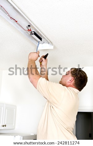 Maintenance Man Installing Light Fixture