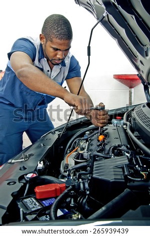 Good Looking Mechanic Working On Car Engine