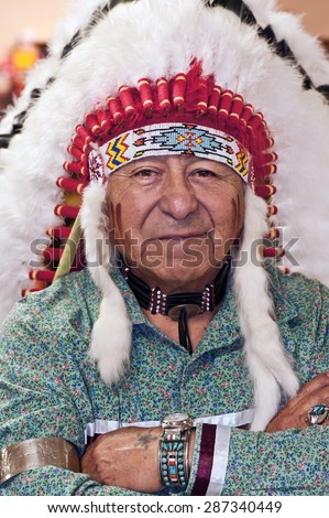 Native American in authentic headdress/ Native American Man Wearing Authentic Headdress