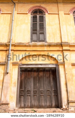 THAILAND - FEBRUARY 15: The side wooden door and the window of abandoned building on February 15, 2014 in Sakon Nakhon Province, The Northeast.