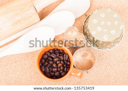 Cup of coffee bean and bakery equipment on table
