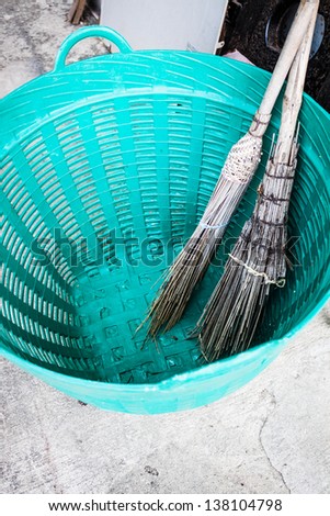 Old brooms after sweeping keep in plastic basket