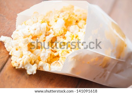 Popcorn packet opened with corn spilling out