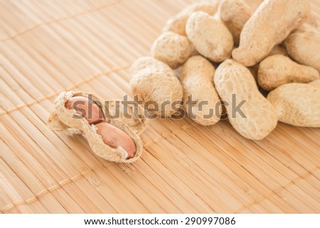 Salted peanuts on kitchen bamboo mat, stock photo
